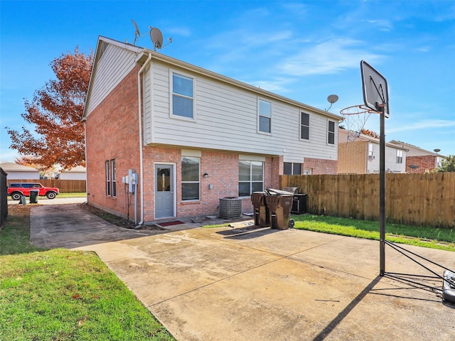 rear view of property with a lawn and a patio