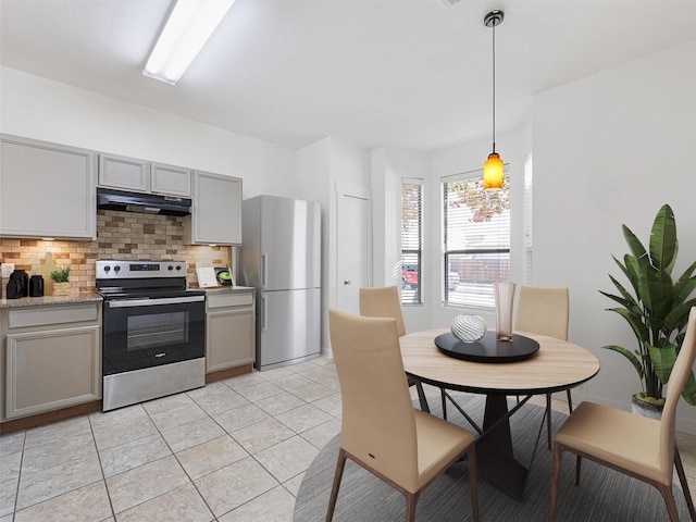 kitchen featuring stainless steel appliances, decorative light fixtures, and gray cabinets