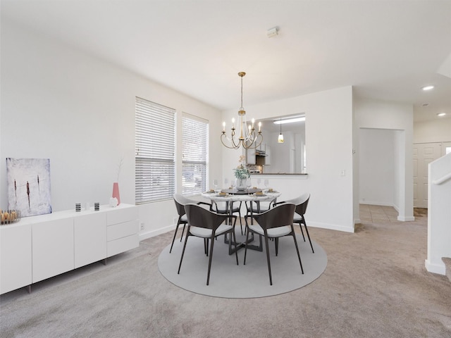 carpeted dining space with a notable chandelier