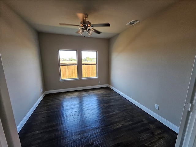 empty room featuring dark hardwood / wood-style floors and ceiling fan