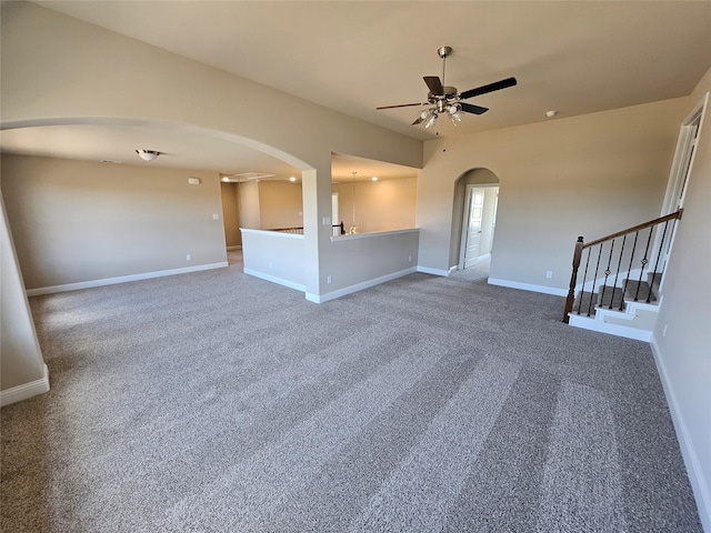 unfurnished living room with ceiling fan and carpet floors