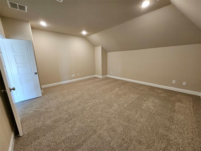 bonus room featuring carpet floors and vaulted ceiling