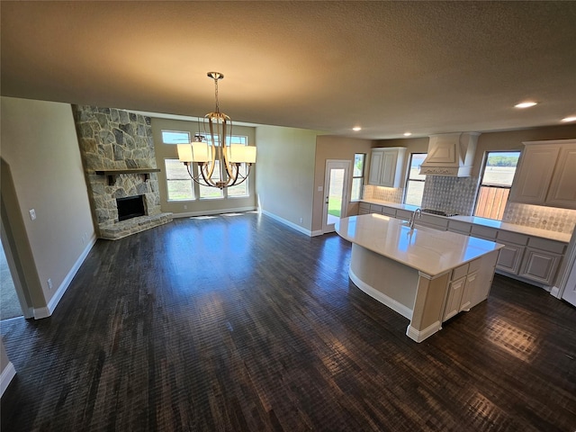 kitchen featuring a center island, a healthy amount of sunlight, and a fireplace