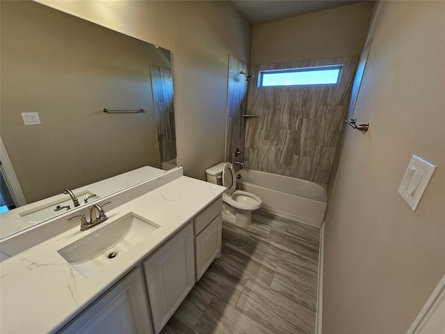 full bathroom with vanity, toilet, and tiled shower / bath