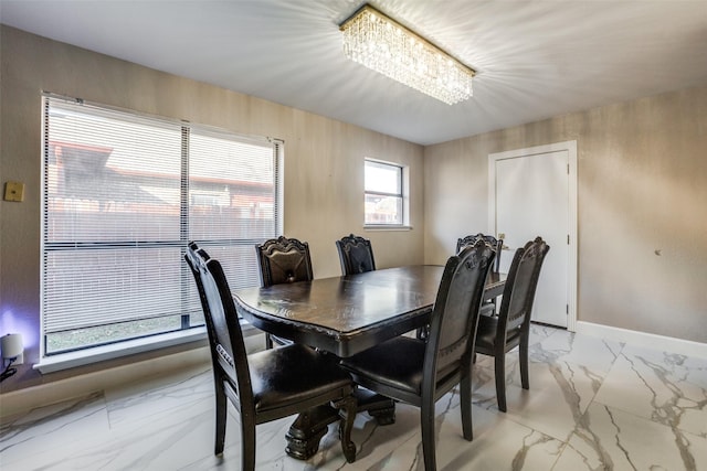 dining space with an inviting chandelier