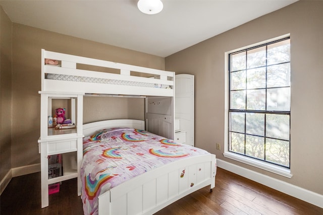 bedroom with dark wood-type flooring