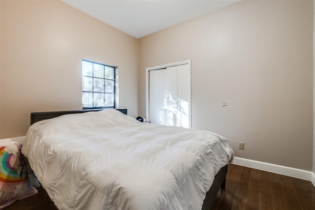 bedroom with a closet and dark hardwood / wood-style flooring