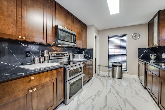 kitchen with appliances with stainless steel finishes, backsplash, and sink