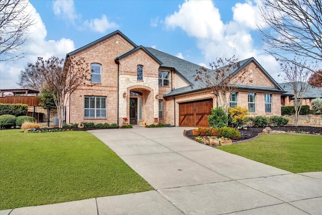 view of front of house with a garage and a front lawn