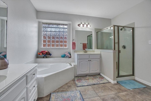 bathroom featuring tile patterned floors, vanity, and plus walk in shower