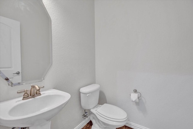 bathroom with toilet and sink