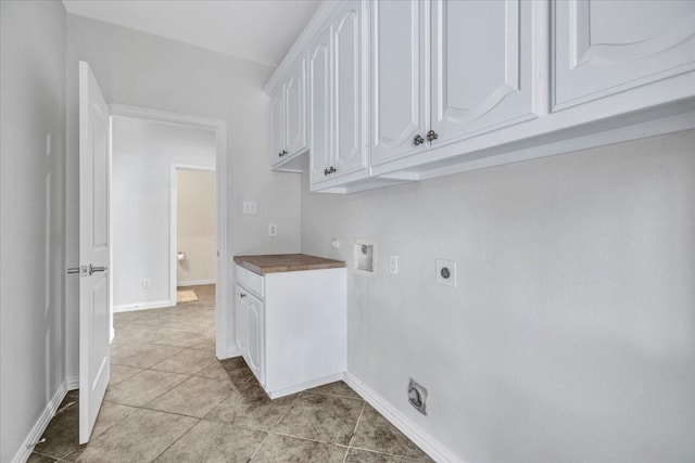 laundry room featuring hookup for an electric dryer, washer hookup, light tile patterned floors, and cabinets