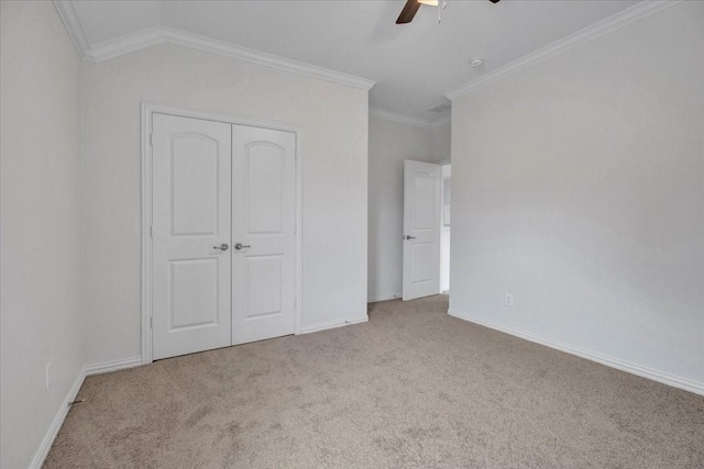 unfurnished bedroom with ceiling fan, ornamental molding, light carpet, and a closet