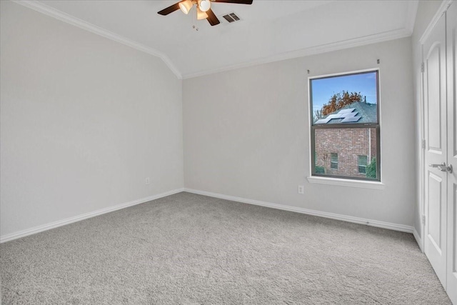 unfurnished room featuring ceiling fan, carpet floors, lofted ceiling, and ornamental molding