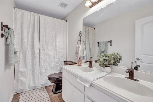 full bathroom featuring tile patterned flooring, vanity, toilet, and shower / bathtub combination with curtain