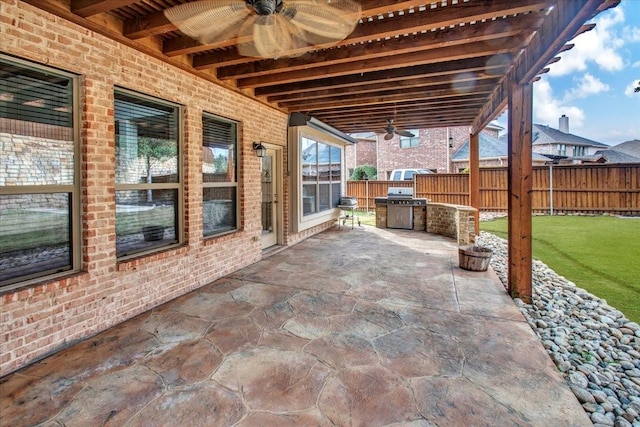 view of patio with area for grilling, ceiling fan, and a grill