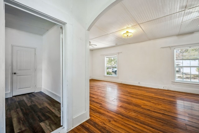 spare room with ceiling fan and dark wood-type flooring