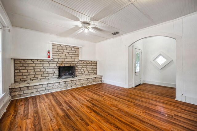 unfurnished living room with hardwood / wood-style flooring, ceiling fan, and a brick fireplace