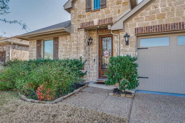 doorway to property with a garage