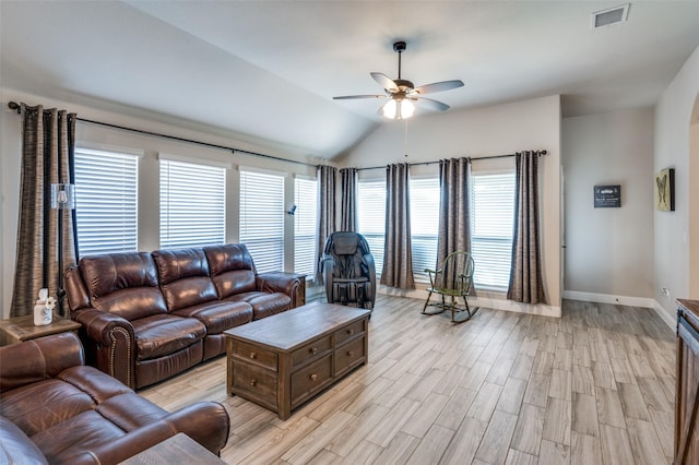 living room featuring ceiling fan, lofted ceiling, and light hardwood / wood-style floors