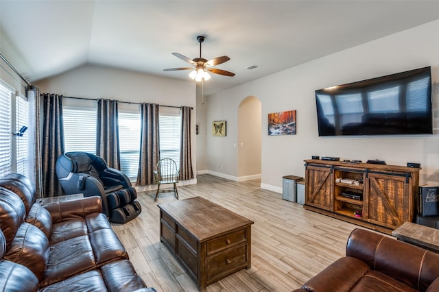 living room with lofted ceiling, ceiling fan, and light wood-type flooring