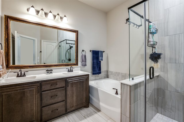 bathroom featuring vanity and independent shower and bath