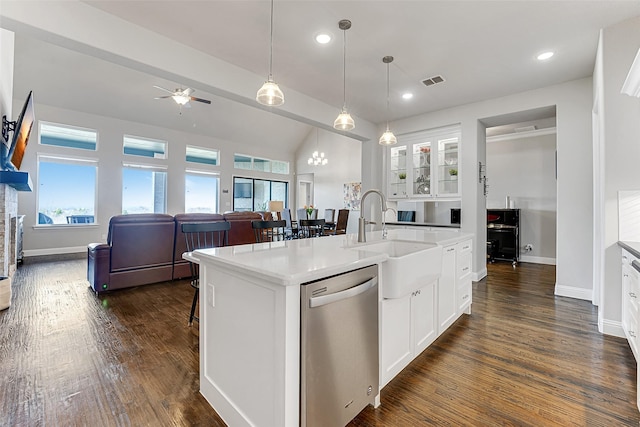 kitchen featuring stainless steel dishwasher, hanging light fixtures, an island with sink, white cabinets, and sink