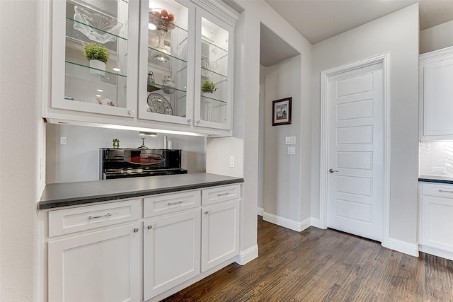 bar featuring white cabinets and dark hardwood / wood-style floors