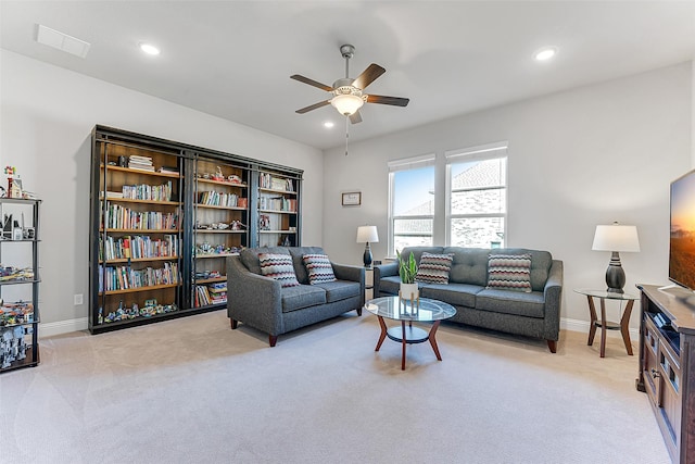 carpeted living room featuring ceiling fan