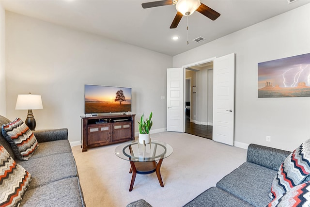 living room featuring ceiling fan and light colored carpet