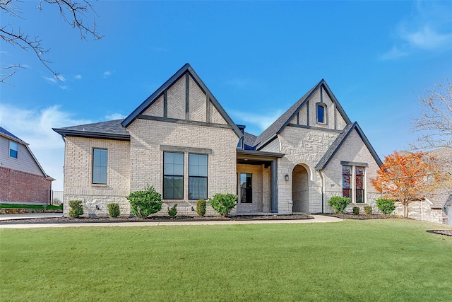 tudor home featuring a front lawn