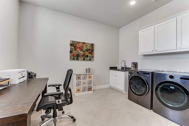 washroom with cabinets, washing machine and clothes dryer, light tile patterned floors, and sink