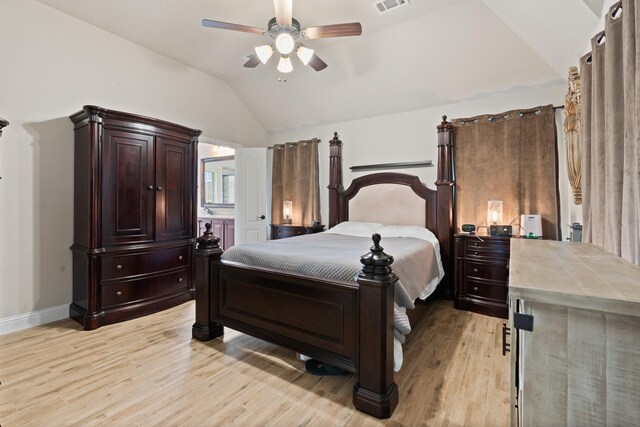 bedroom with ensuite bath, ceiling fan, light hardwood / wood-style floors, and vaulted ceiling