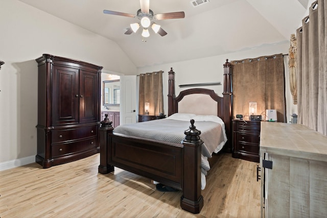 bedroom featuring vaulted ceiling, ensuite bathroom, ceiling fan, and light hardwood / wood-style flooring