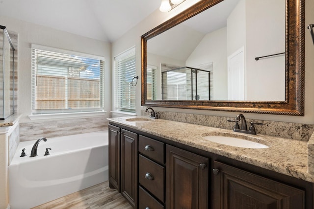 bathroom featuring separate shower and tub, vanity, lofted ceiling, and hardwood / wood-style flooring