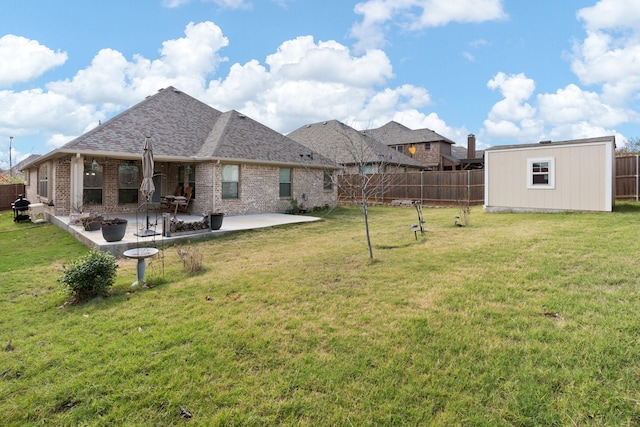 view of yard with a storage unit and a patio area