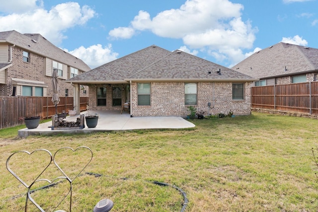 rear view of property with a lawn and a patio