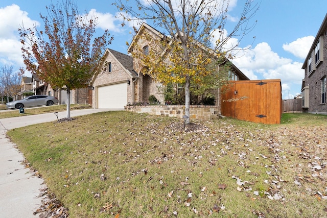 view of property hidden behind natural elements featuring a garage and a front yard