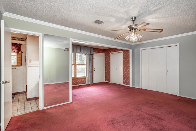 unfurnished bedroom with ceiling fan, crown molding, carpet floors, and tile walls