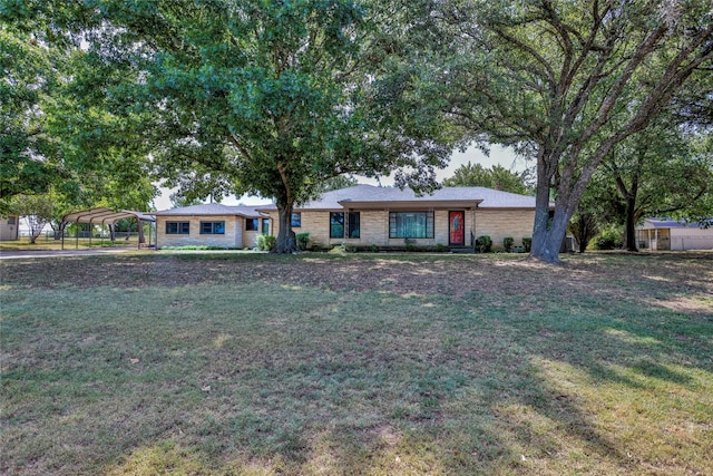 ranch-style house with a front yard and a carport