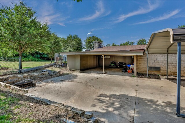 view of patio / terrace with a carport and an outdoor structure