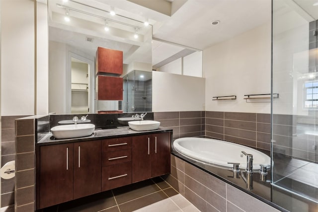 bathroom featuring tile patterned floors, plus walk in shower, and vanity