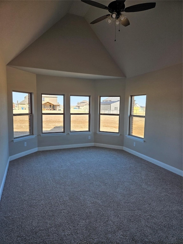 carpeted empty room featuring ceiling fan and lofted ceiling