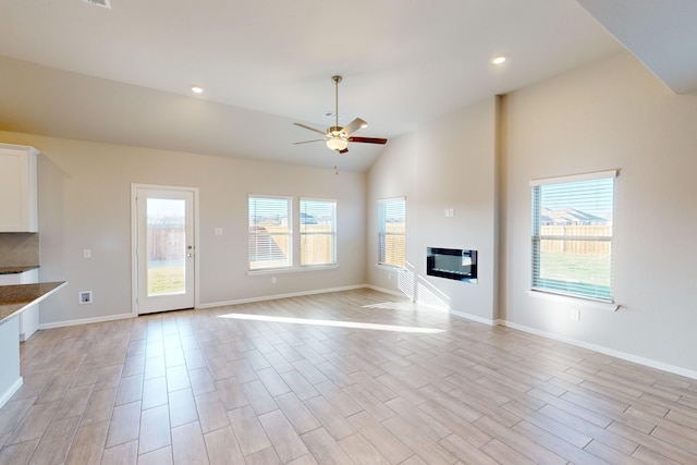 unfurnished living room featuring high vaulted ceiling, ceiling fan, and heating unit