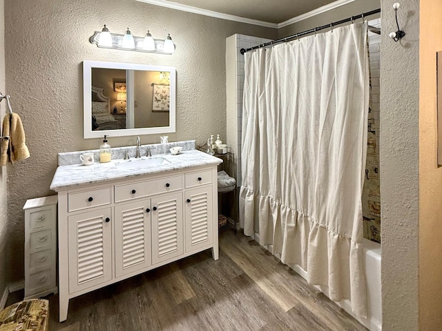 bathroom featuring wood-type flooring, shower / tub combo, vanity, and crown molding