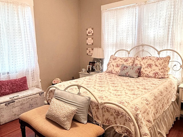 bedroom with dark hardwood / wood-style flooring