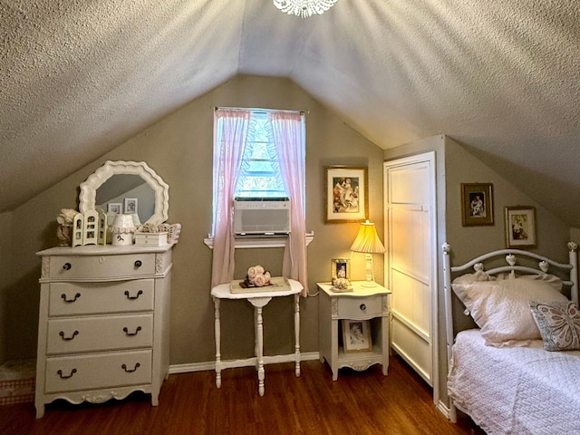 bedroom with dark hardwood / wood-style floors, vaulted ceiling, and a textured ceiling