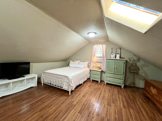 bedroom featuring dark hardwood / wood-style flooring, lofted ceiling, and a textured ceiling