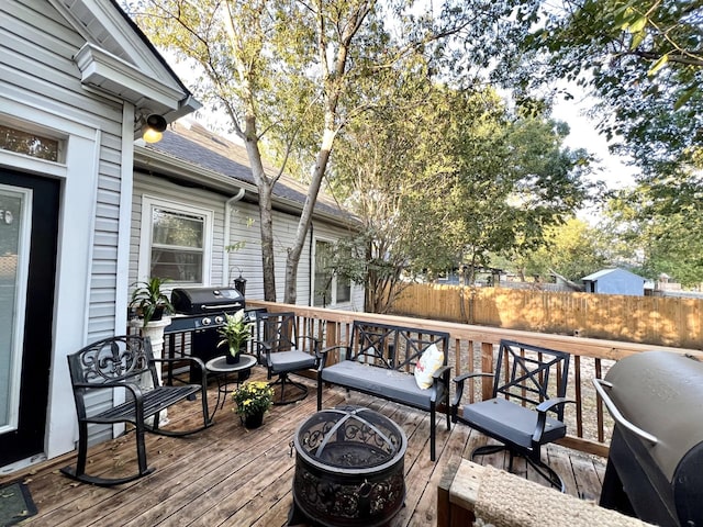 deck featuring grilling area and a fire pit