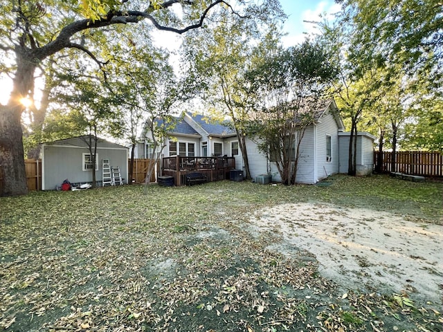 view of yard with a wooden deck and central AC